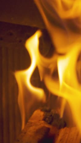 Vertical-Video-Close-Up-Flames-Fire-Logs-In-Wood-Burning-Stove-At-Home-1